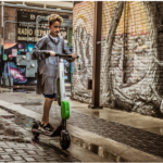 a boy riding a scooter
